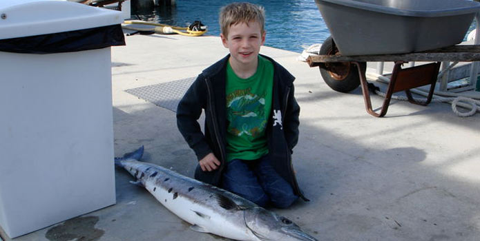 deerfield beach kid friendly fishing charter kid catches a wahoo on fishing trip